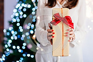 Close up on woman hands giving Christmas present.