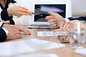 Close up of woman hands giving a pen to businessman for contract signing