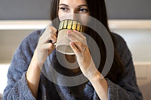 Woman hands holding big mug beverage tea or coffee cup,female drinking hot chocolate drink