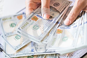 Close up woman hands holding and counting bunch of America dollars banknotes