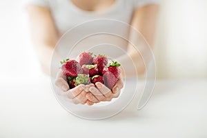 Close up of woman hands holding strawberries