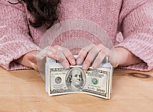 Close up of woman hands holding us dollar and euro money