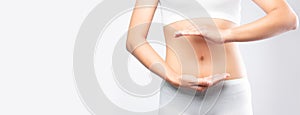 Close up woman hands made protect shape stomach isolated on white background banner size.health care digesting concept photo
