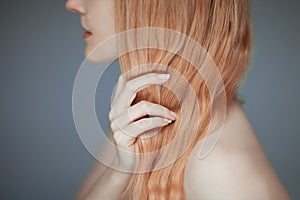 Close up woman hands maintain her hair, sensual look photo