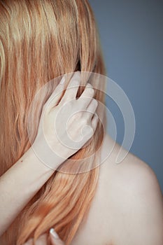 Close up woman hands maintain her hair, sensual look