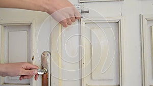 Close up of woman hands opening the old close door