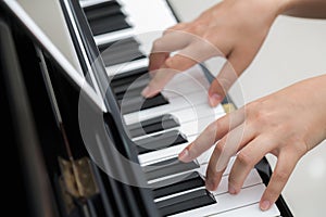 Close up of woman hands playing piano background