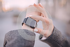 Close-up of woman hands setting smart watch
