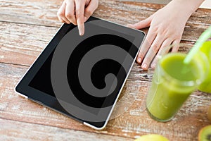 Close up of woman hands tablet pc and fruit juice