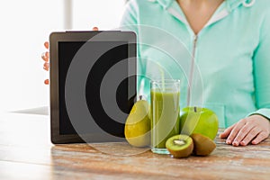 Close up of woman hands tablet pc and fruit juice