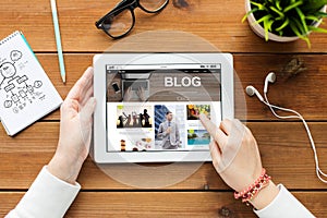 Close up of woman hands with tablet pc on table