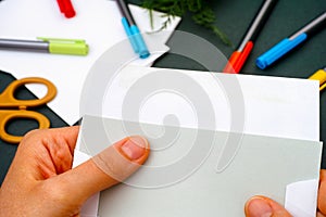 Close up of woman hands taking out letter from envelope