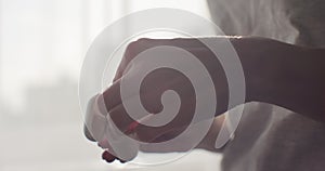 Close-up of a woman hands taking out a wireless ear phones from charging box.