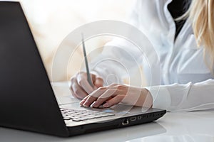 Close up of a woman hands typing on a keyboard. Distance learning, education online. Online working from home, business