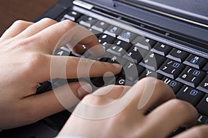 Close up of woman hands typing in the laptop compu