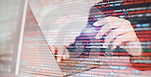 Close up of woman hands typing on laptop keyboard with program code on screen