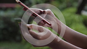 Close-up woman hands typing smartphone, and make credit card payment