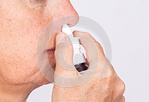 Close up of woman hands using nasal spray