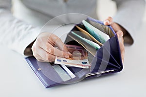 Close up of woman hands with wallet and euro money