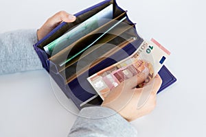 Close up of woman hands with wallet and euro money