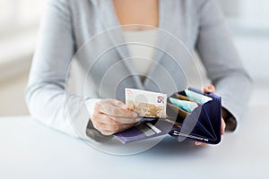 Close up of woman hands with wallet and euro money