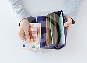 Close up of woman hands with wallet and euro money