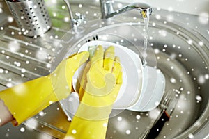 Close up of woman hands washing dishes in kitchen