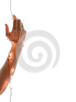 Close up of woman hands wrapped in New Year`s light. Gesture of getting ready for New Years eve.