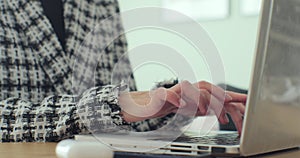 Close up woman hands writing on laptop computer keyboard. Business person typing on laptop keyboard at the desk in home