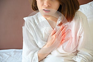 Close-up of woman having chest pain or heart attack.