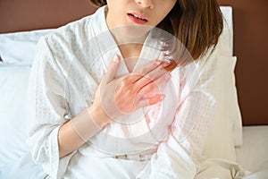 Close-up of woman having chest pain or heart attack.