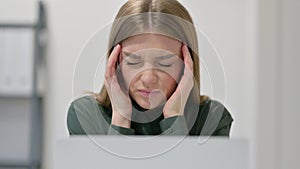 Close Up of Woman having Headache while using Laptop