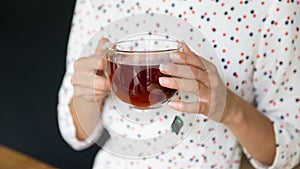 Close up of woman hold cup drink black tea