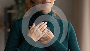 Close up of woman hold hands in prayer feeling grateful
