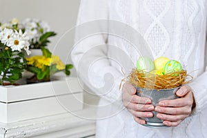 Close up Woman holding basket easter eggs.