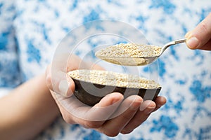 Close Up Of Woman Holding Bowl Of Amaranth