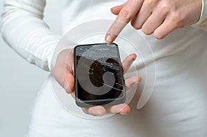 Close up of woman holding broken mobile phone