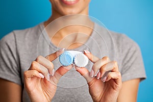 Close up of woman holding container with contact lenses