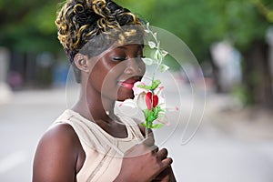 Close up of woman holding a flower in her hand