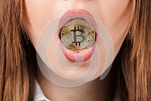 Close up of a woman holding golden bitcoin