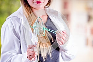 Close up of woman holding in her hands a nebulizer for asthma and respiratory diseases at home