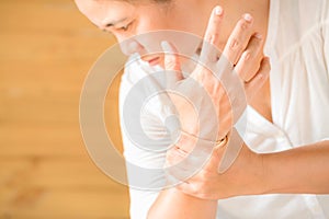 Close up woman holding her wrist symptomatic Office Syndrome