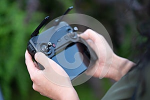 Close up of Woman Holding Joystick Remote Controller of Wireless Quadcopter Drone With Video and Photo Camera For Aerial