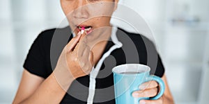 Close up woman holding pill in hand with water feeling sick. female going to take painkiller from headache, painkiller