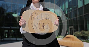 Close up woman holding poster cardboard with need job jobless message. Global unemployment.