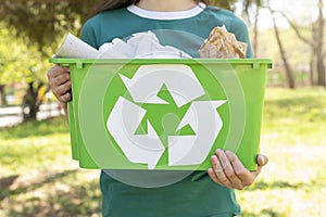 Close up woman holding recycling basket nature. High quality and resolution beautiful photo concept