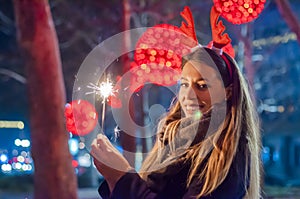Close up of woman holding sparkler on the street