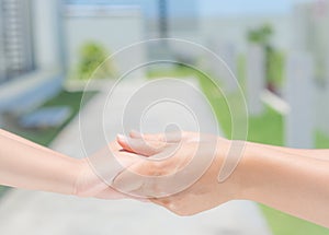 Close up of woman holds the hand of a lovely child.