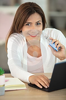 close up woman inhaling from electronic cigarette