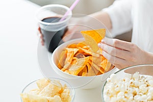 Close up of woman with junk food and coca cola cup